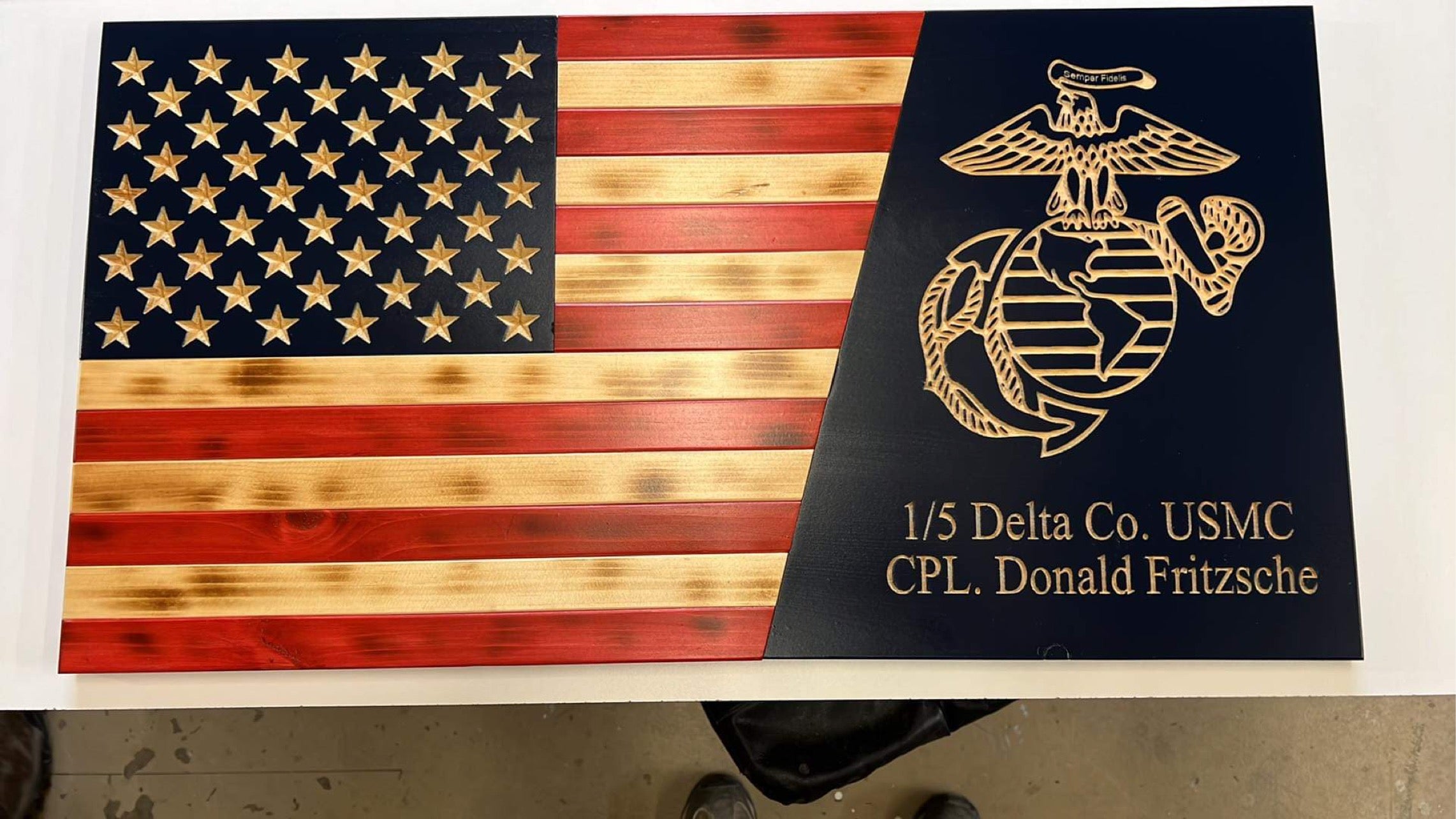 Handcrafted Wooden Marine Corps Flag

This handcrafted wooden Marine Corps flag is precision CNC-carved and built to honor the pride, sacrifice, and tradition of the United States Marine Corps. The American flag features deeply carved stars and stripes with a rich, hand-finished stain, while the contrasting black field showcases the iconic Eagle, Globe, and Anchor in crisp detail. Custom engraving includes unit designation and service member name, making this piece a powerful personalized tribute.

Made fro