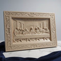 Wooden relief sculpture of 'The Last Supper' on a marble surface with a gray background